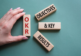 OKR objectives and key results symbol. Wooden blocks with words OKR objectives and key results....