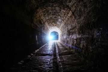 Naklejka premium Dark and creepy old historical vaulted underground road tunnel