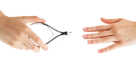 Female hands with tweezers cut cuticle.