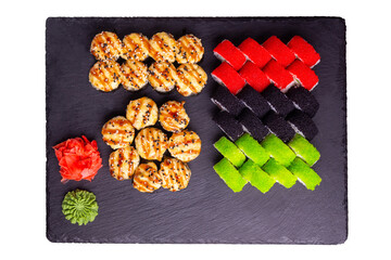 Sushi set with ginger and wasabi on a slate plate isolated on white background. 5 types of rolls in one set. Top view.