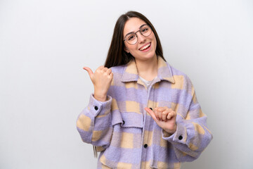 Young girl isolated on white background pointing to the side to present a product