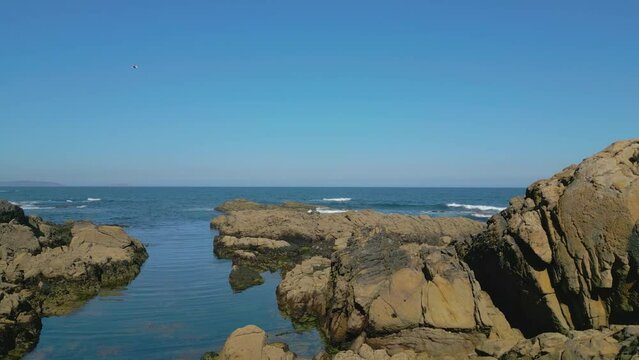 Aerial View Of Rocky Coast And Blue Sea In Summer