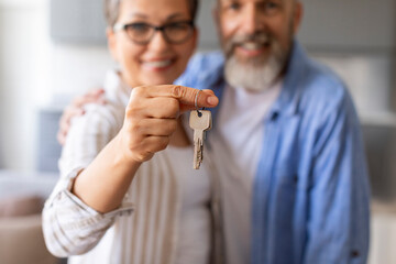 Real Estate Concept. Happy Senior Couple Holding Home Keys, Showing To Camera