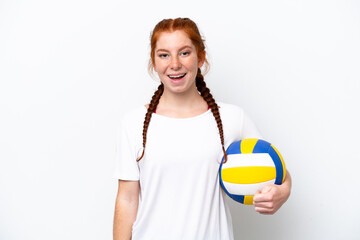 Young caucasian reddish woman playing volleyball isolated on white background with surprise facial...