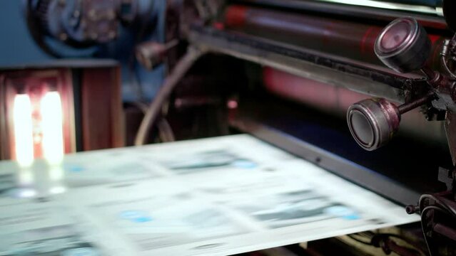 Fleyers and leaflets being printed in a printing house factory