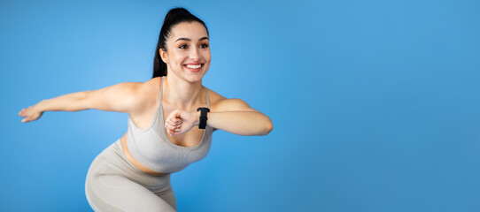 Obraz premium Motivated young sportswoman running over blue background, web-banner