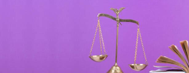 Law concept - Open law book, Judge's gavel, scales, Themis statue on table in a courtroom or law...