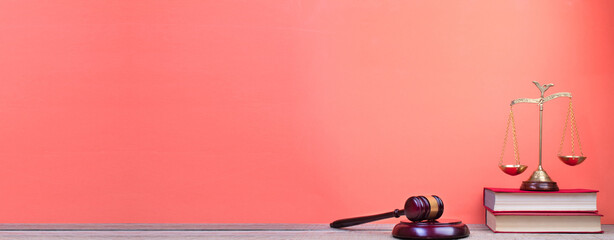 Law concept - Open law book, Judge's gavel, scales, Themis statue on table in a courtroom or law...