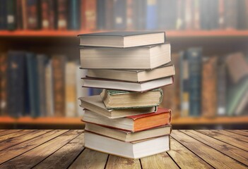 Stacks of old reading books on desk in library.