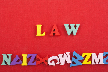 LAW word on red background composed from colorful abc alphabet block wooden letters, copy space for...