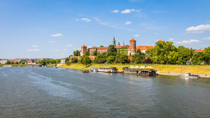 Historic city centre of Krakow, Poland with Wawel castle and Wisła river on a beautiful summer day as part of the UNSESCO World heritage - obrazy, fototapety, plakaty