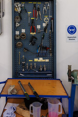  various tools hanging on the wall in a car repair shop