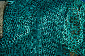 Green fishing trawl ned on a fishing boat.