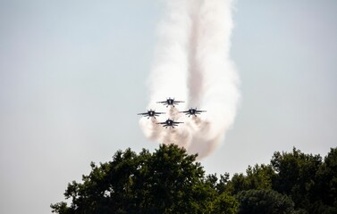 Scene of the military aircrafts in the air emitting smoke during the air show