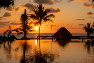 Sunrise over the Gulf of Mexico reflected into the infinity pool at the resort