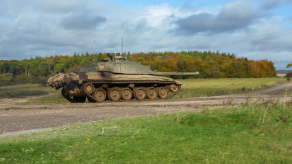 Commander and gunner directing a British army FV4034 Challenger 2 ii main battle tank moving along...