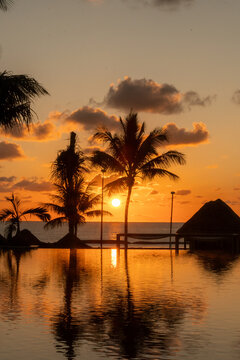 Sunrise over the Gulf of Mexico reflected into the infinity pool at the resort