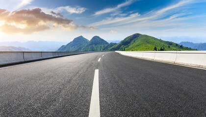 straight asphalt road and mountain under blue sky highway and mountain background