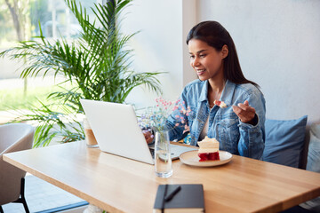 Woman having coffee break with laptop at cafe