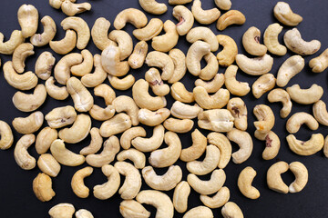 Cashew nuts on dark background.
