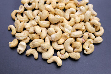 Cashew nuts on dark background.