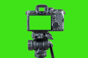 Photo camera. Digital or Dslr camera on tripod. Green screen or Chroma key. Photographer or videographer studio for recording film video project. Professional blogger, television equipment