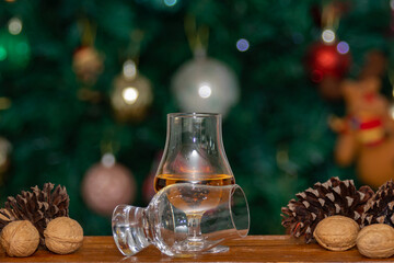 Obraz na płótnie Canvas Traditional Christmas themed background and Scottish single malt whiskey in crystal tasting glass