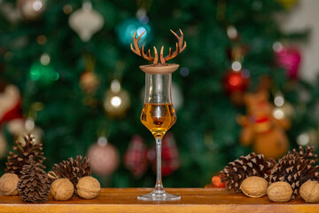 Traditional Christmas themed background and Scottish single malt whiskey in crystal tasting glass