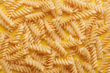 Uncooked fusilli pasta. Uncooked italian pasta. Top view.