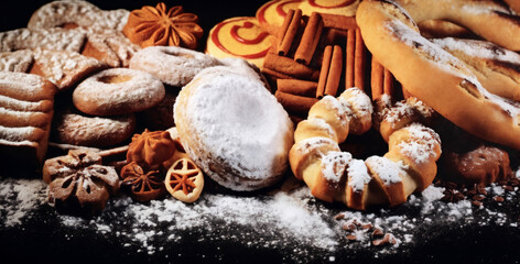 Fototapeta premium still life of cookies with chocolate on a wooden table, dark background, delicious pastries
