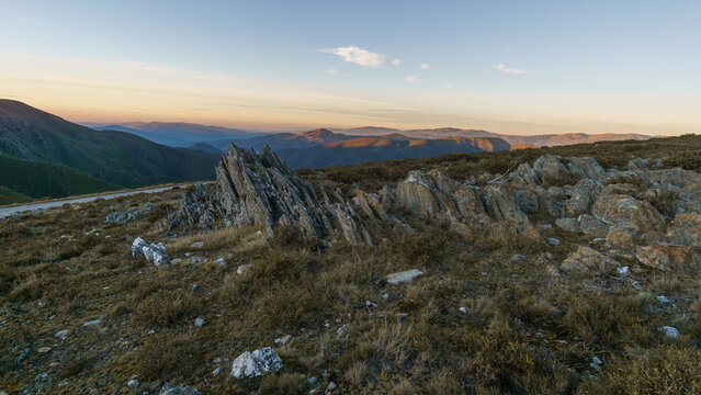 View from Serra da Arada over mountain landscape at evening sunset with sharp rocks in foreground, Sao Pedro do Sul, Portugal