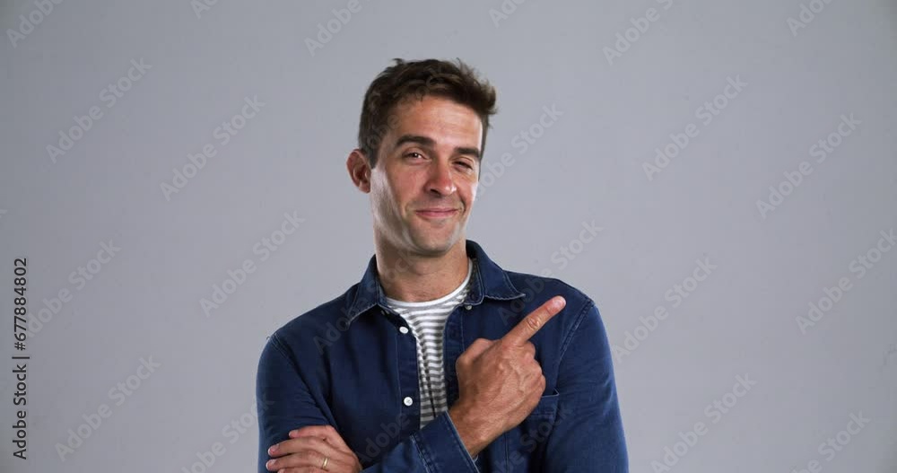 Aufkleber face, presentation and pointing with a young man in studio isolated on a gray background for an anno