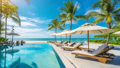 Tuinposter panoramic holiday landscape luxury beach poolside resort hotel swimming pool beach chairs beds umbrellas palm trees relax lifestyle blue sunny sky summer island seaside leisure travel vacation © Art_me2541