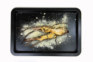 baked oat root with parmesan cheese on a black background