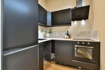 a kitchen with black cabinets and white marble counter tops on the counters in this is an example...