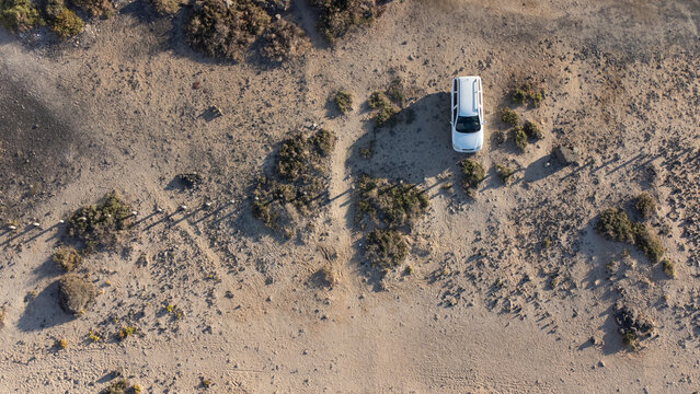 Van life in Lanzarote, caleta de caballo, aerial view of camper RV parked on the side of the ocean