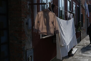 Some laundry drying in the street of Murano. Venice, Italy - November 12, 2023.