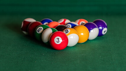 Close-up of a pool table with vibrant billiard balls, inviting a game of precision and skill