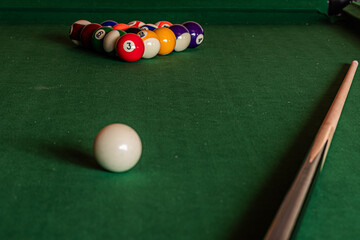 Close-up of a pool table with vibrant billiard balls, inviting a game of precision and skill