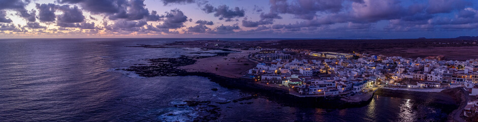 Panoramic view of El Cotillo bay, aerial high above point of view drone digital nomad night...