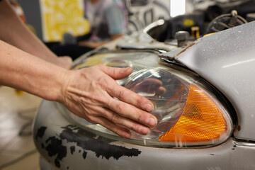 Big headlight cleaning on the car with power buffer machine at service station ,Before and after...