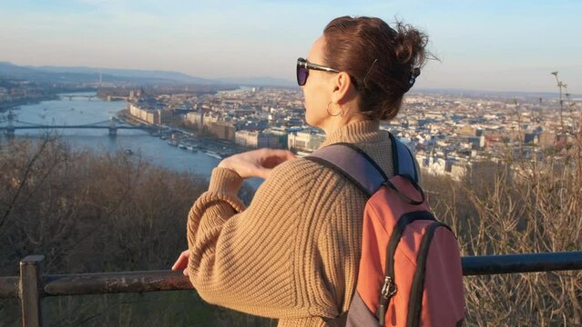 Female tourist enjoys the views of budapest on the observation deck