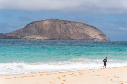 Hiking trakking to la Playa de las Conchas with Mount Clara in the background. The island La Graciosa, Lanzarote, Canary Islands, Spain