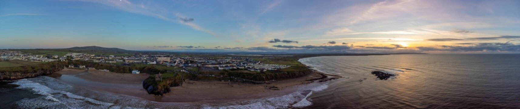 Aerial panoramic view of of Ballybunion, Ireland with beaches, town, mountains and golf cours
