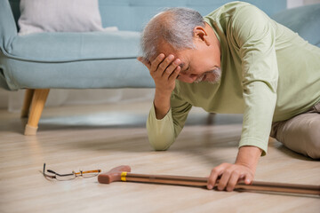 Older senior man headache lying on the floor after falling down he pain and hurt from osteoporosis,...