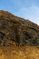 Rocky frozen mountains in nordic valley forming majestic scandinavian landscape, countryside fields and hills. Picturesque cliffs in icelandic highlands, beautiful wilderness.