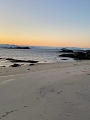 Fototapeta na wymiar View of an empty beach and sea at sunset.
