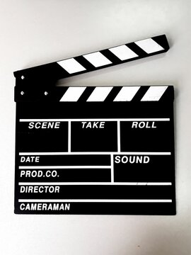 Vertical closeup of a clapperboard isolated on a white background.