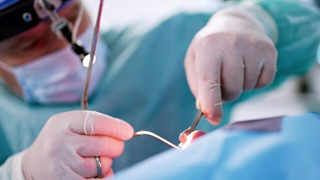 Metal tools in the nasal cavity of a patient. Male doctor performs functional rhinoplasty. Close up.