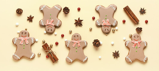 Christmas gingerbread cookies, cones and different spices on yellow background
